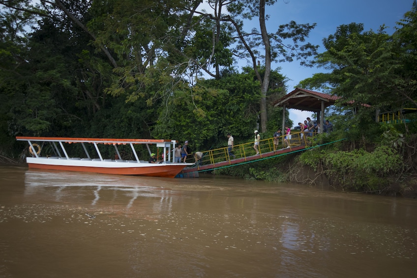 Tour group boarding river boat in San Jose