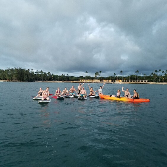 Large group on a stand-up paddle boarding adventure at Haleiwa Beach Park 