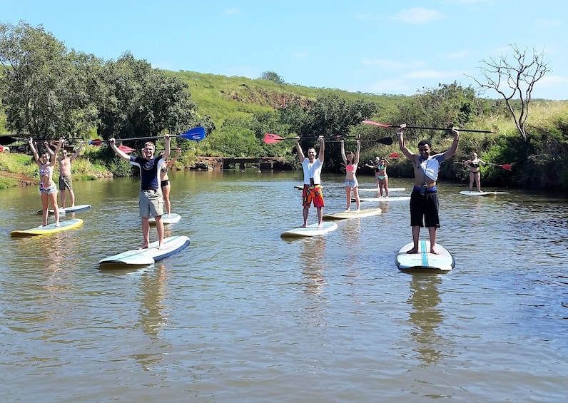 Group on stand-up paddle boarding tour in Haleiwa Beach Park