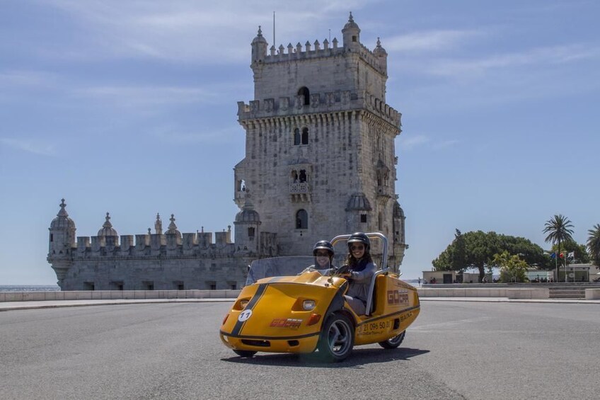 Couple driving a Go Car around Lisbon