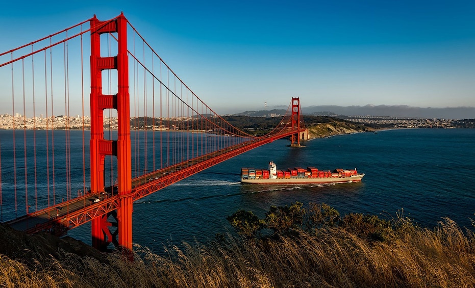 Boat sails under the Golden Gate Bridge in San Francisco, California
