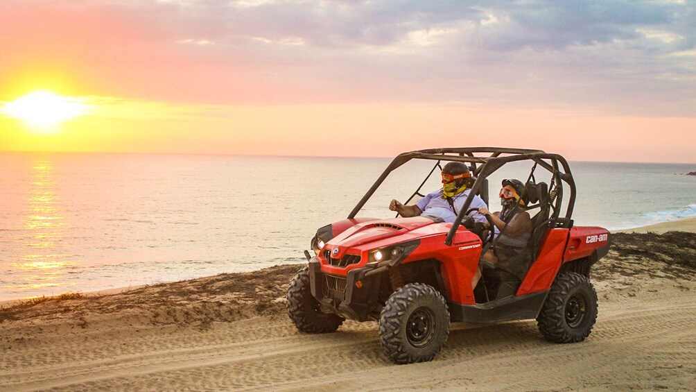 People in a UTV on the coast in Los Cabos