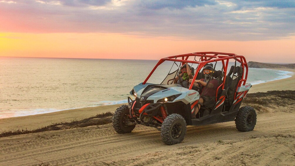 People in a UTV on the coast in Los Cabos