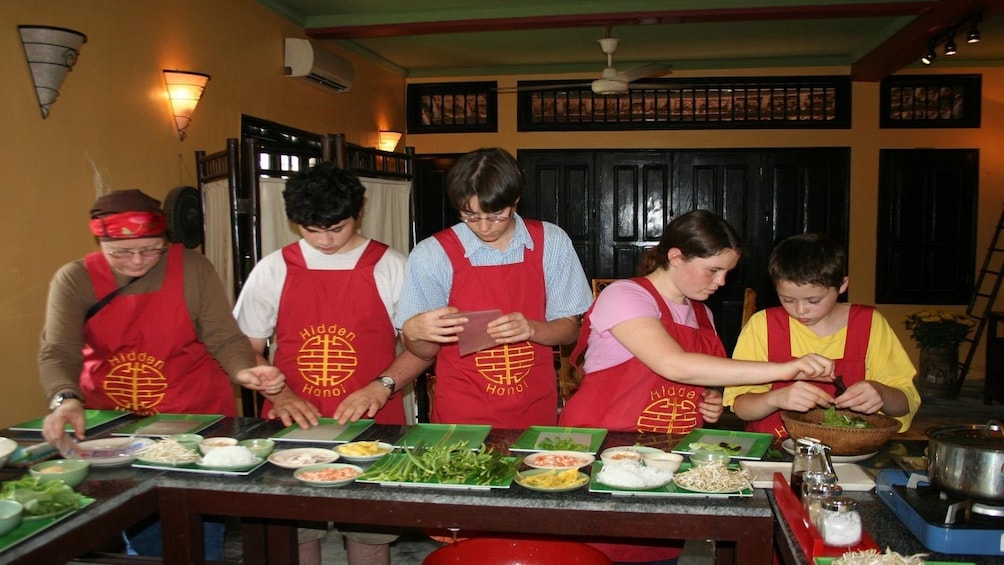 Guests learning how to cook Vietnamese food at a cooking class in Ho Chi Minh City