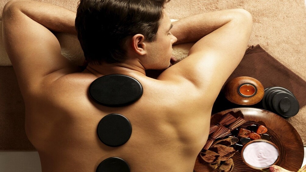 Man relaxing while having a stone massage in Ho Chi Minh city