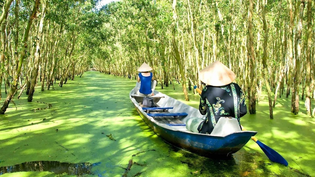 Locals cruising down the Mekong River by boat in Vietnam