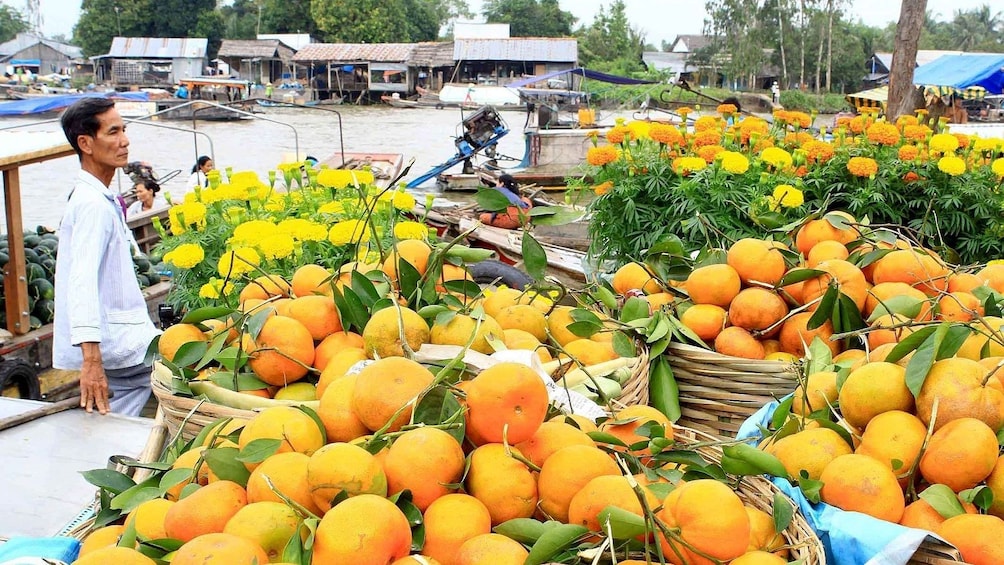 Closeup of large baskets of oranges and flowers in Vietnam