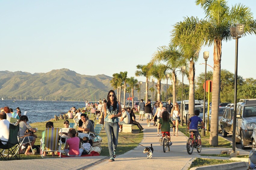 People congregate at the coastline in Villa Carlos Paz