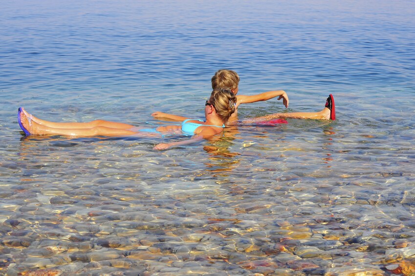 Two people floating in the Dead Sea