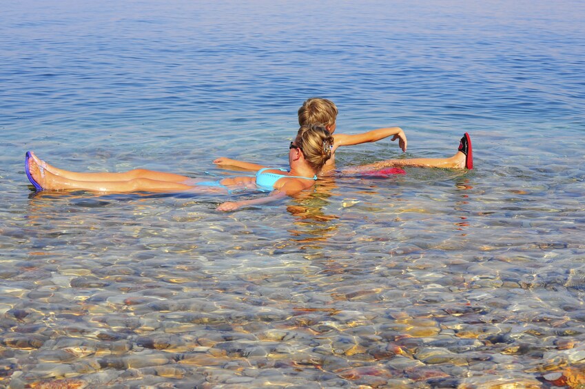 Woman and child floating in the Dead Sea