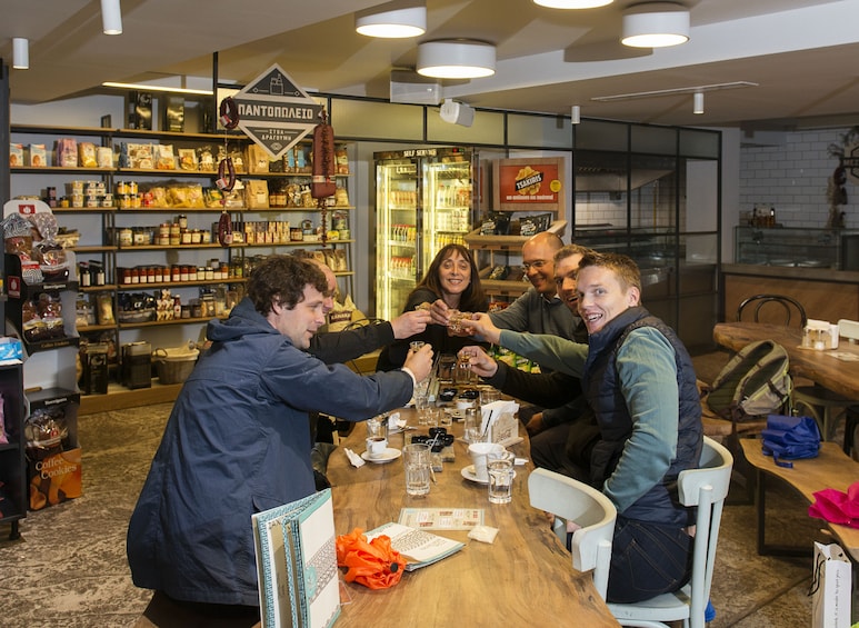 Show item 2 of 4. Group toasting drinks on a food tour in Thessaloniki