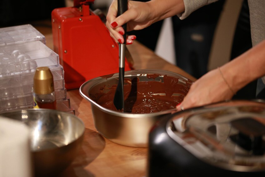 woman stirring chocolate at a workshop in Belgium