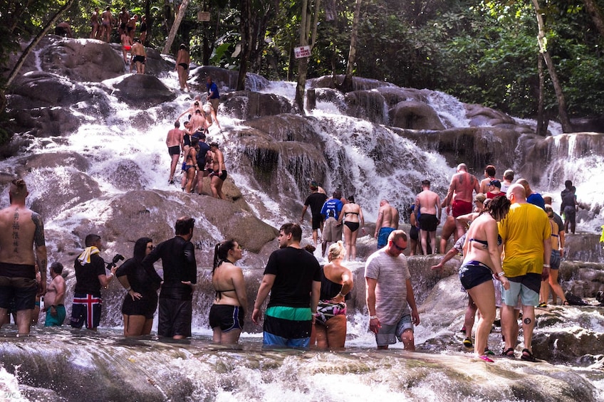 Tourists wait to climb Dunn's River Falls in Ocho Rios, Jamaica