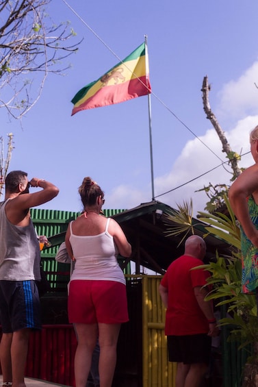 Tourists gaze at a Rastafarian flag in Nine Miles, Jamaica