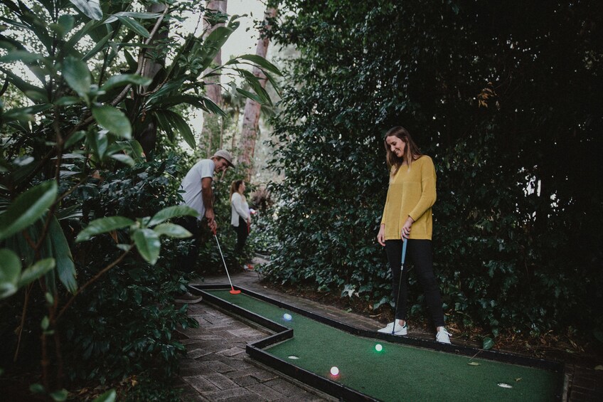 Couple playing mini golf at Wanneroo Botanic Gardens