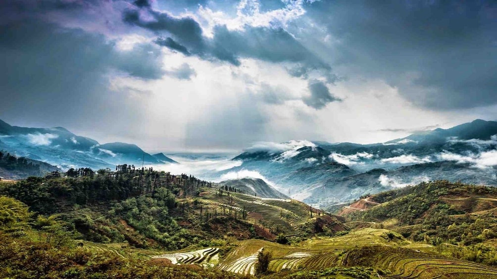 Sun shines through clouds onto Sa Pa Valley in Vietnam