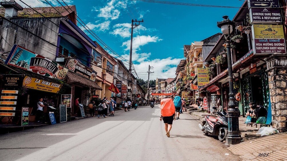 Street lined with restaurants on a sunny day in Vietnam