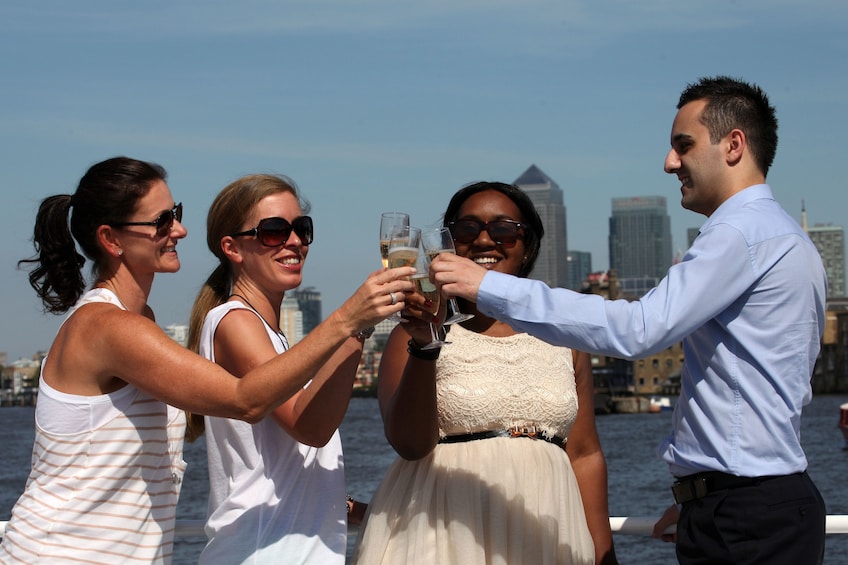 Group of friends on a cruise boat on the River Thames