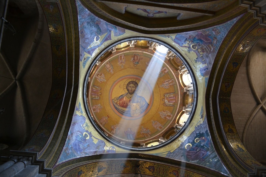 Light streaming through ceiling mural in a church in Jerusalem