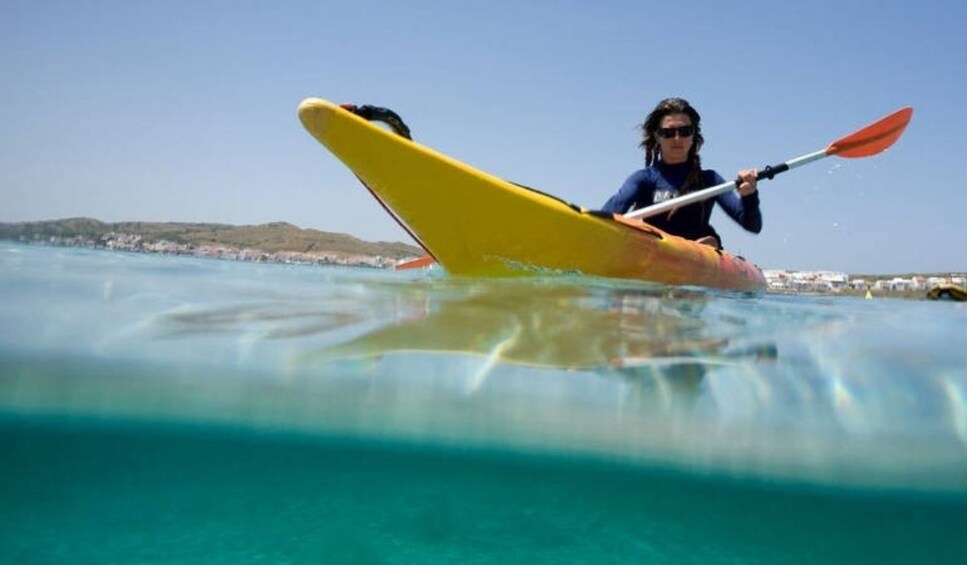 Woman kayaking in Fornells 