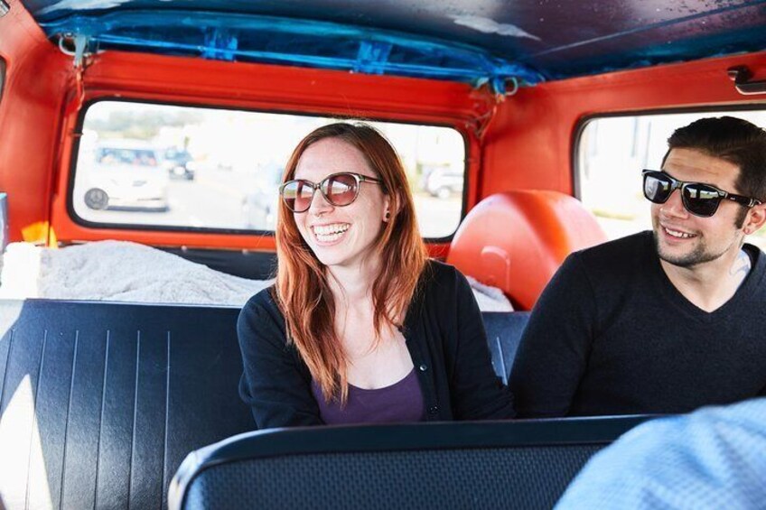 Travelers take in the sights from the back of a jazzed up VW Camper Van in San Francisco.