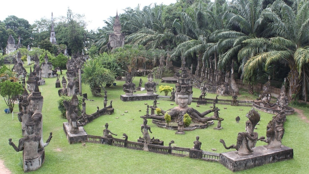 Religious statues and palm grove in Vientiane