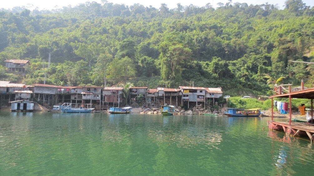 Homes on stilts at the edge of the Mekong River in Laos