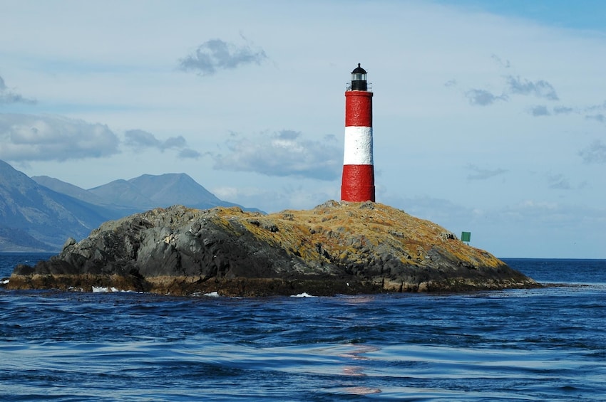 Red and white lighthouse on small island in Beagle Channel
