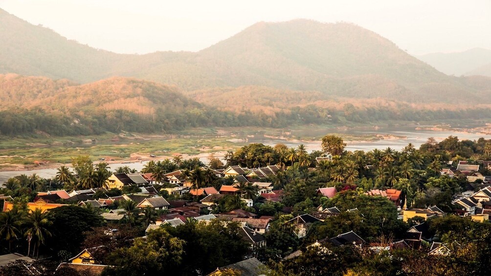 Homes and Mount Phousi on a foggy morning in Luang Brabang, Laos