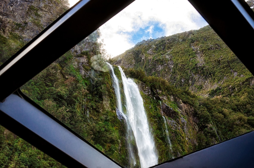 Waterfall as seen from a boat in Milford Sound in New Zealand