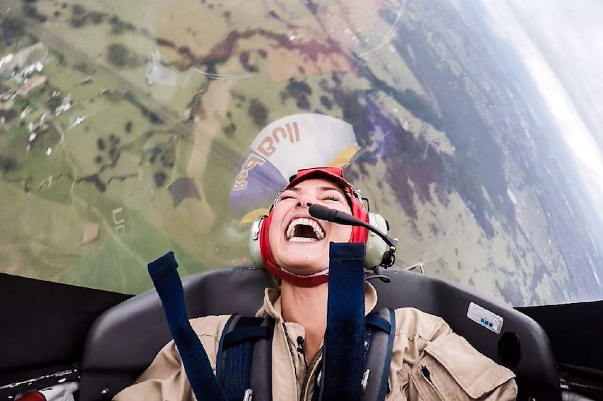Show item 4 of 4. Smiling woman in a small airplane in Sydney