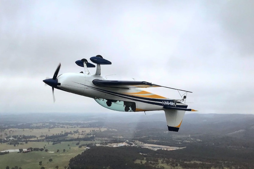 Small airplane flying upside down in Australia