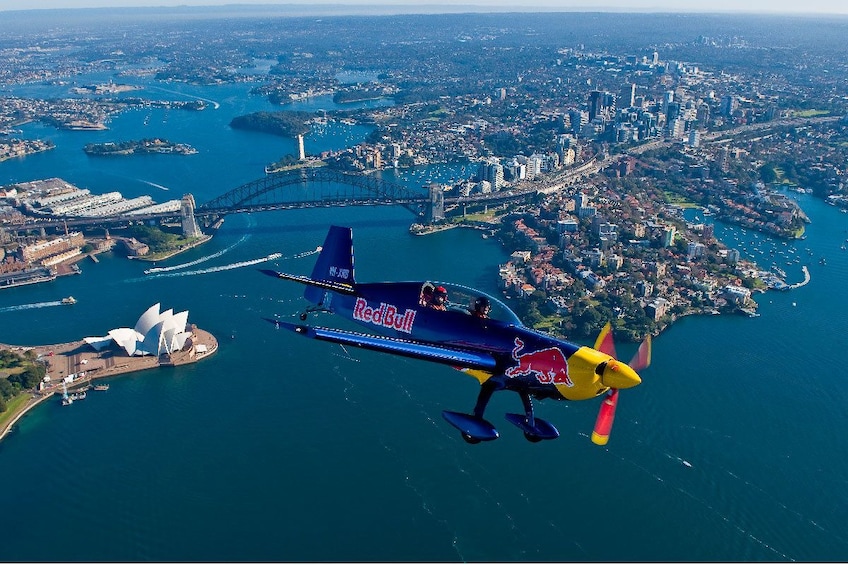 Small airplane flying over the city in Sydney