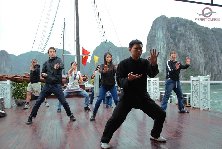 People doing Taichi exercise on the boat deck in Halong Bay