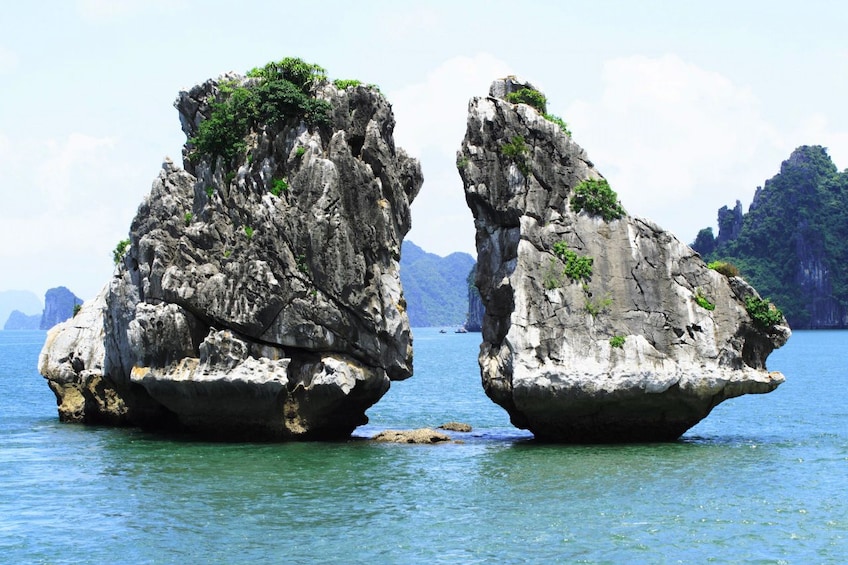 Closeup of two large rock formations in Halong Bay