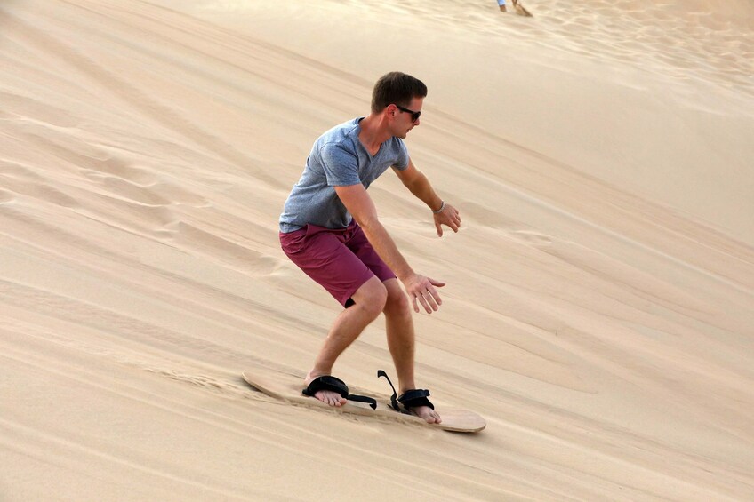 Man sand boarding in Abu Dhabi