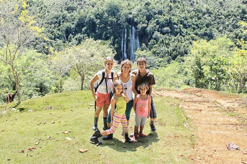 Tourists pose in front of El Limon waterfall