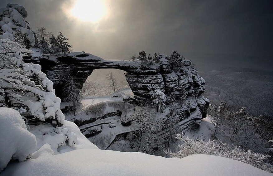 Rock arch covered in snow in the mountains of Switzerland