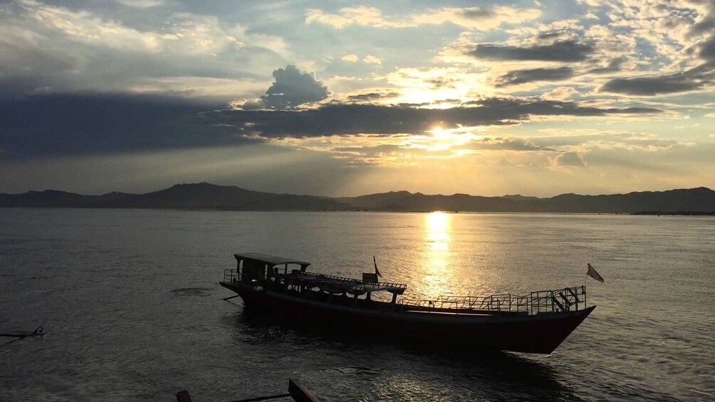 Boat at sunset on Irrawaddy River in Myanmar