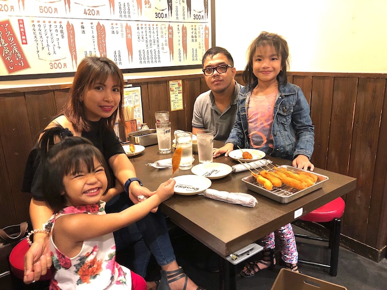 Family eating food at a restaurant in Osaka