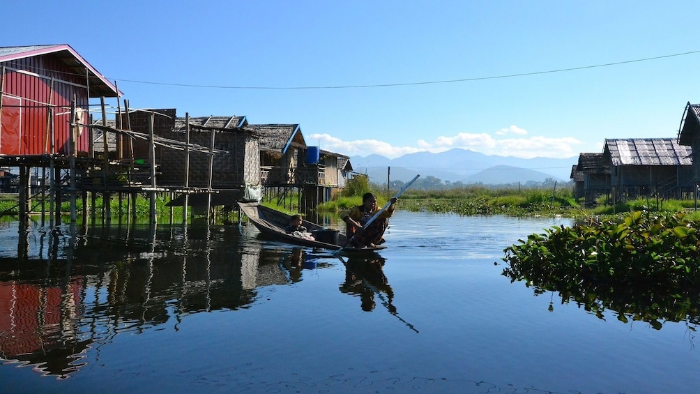 Locals on a wooden boat on Inle Lake in Myanmar