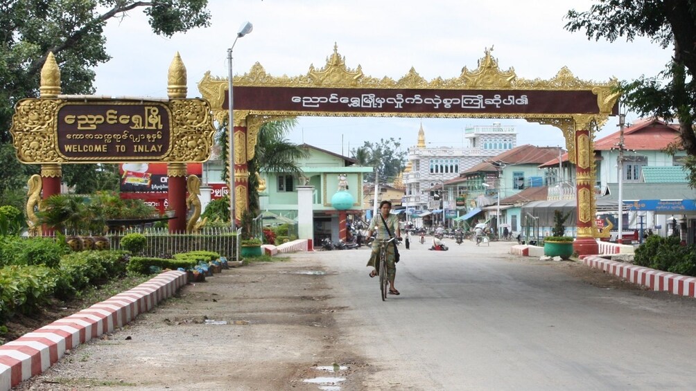 Man bikes down city street in Myanmar