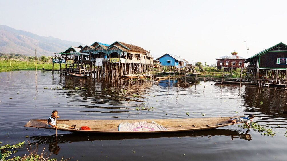 Locals on a boat in Nyaungshwe, Myanmar 