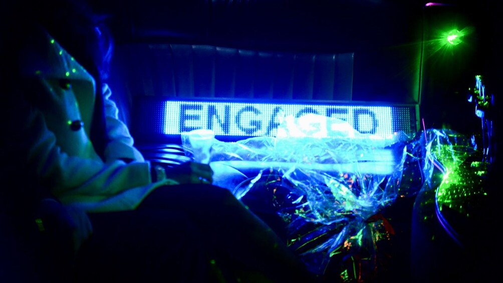Light tastefully announcing a couple's engagement in neon in a limo in Paris