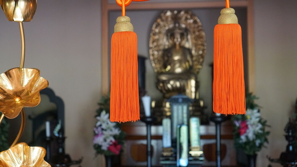 Two hanging bunches of orange silk in yoga studio