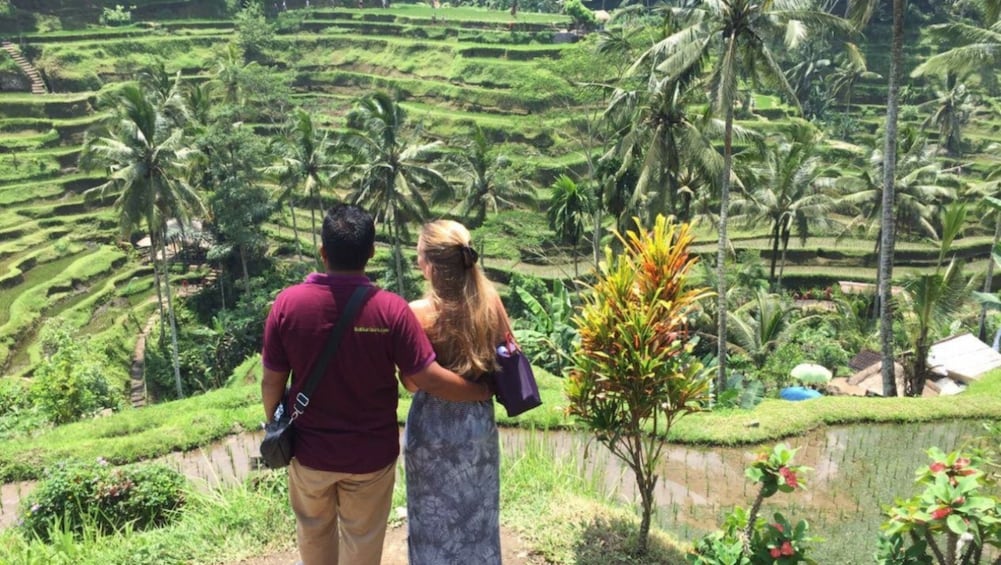 Show item 3 of 8. Couple looking out at terraced field in Bali