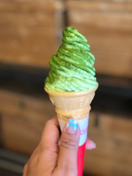 A green tea ice cream in a cone