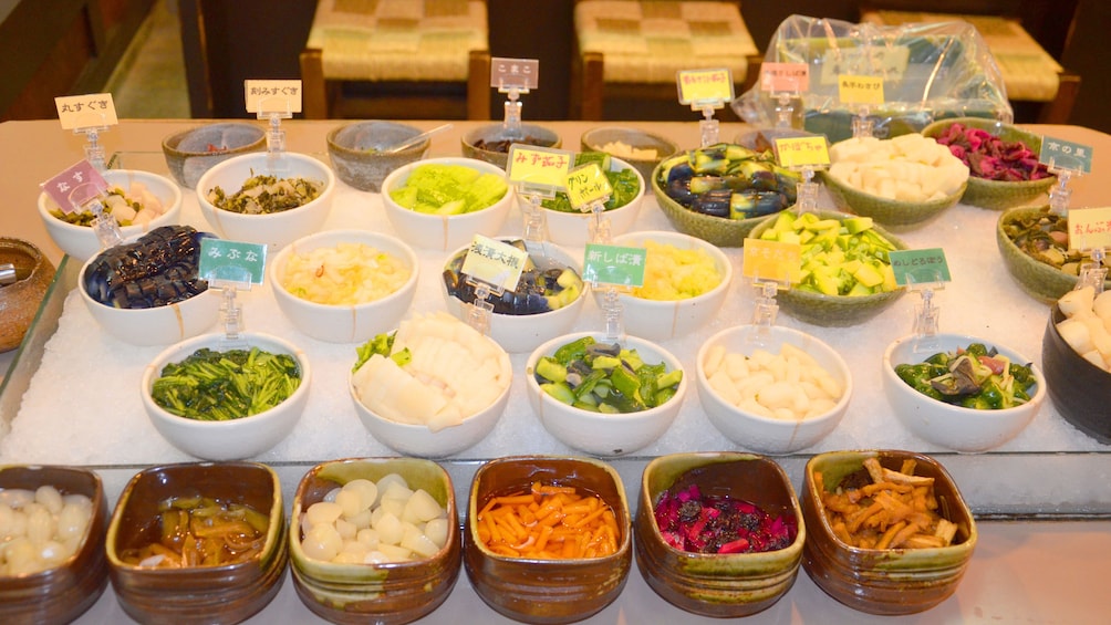 Bowls of chopped vegetables and proteins at a Kyoto market