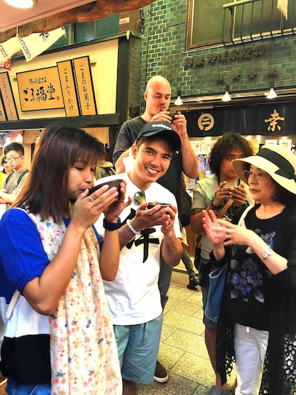 People drinking soup in a Kyoto market