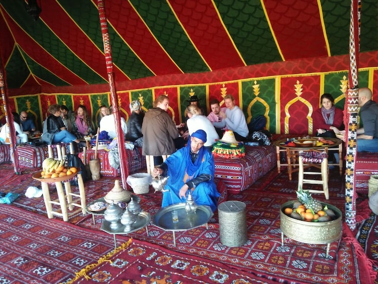 Tourists enjoy traditional Berber breakfast in Adagir, Morocco